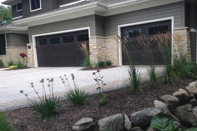 Inspiration for a mid-sized modern partial sun front yard brick driveway in Milwaukee.