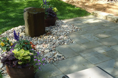 Design ideas for a small rustic partial sun backyard stone landscaping in Minneapolis for summer.