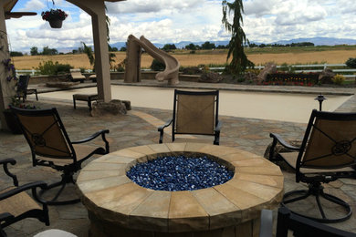 Patio - mid-sized southwestern backyard stone patio idea in Boise with a fire pit