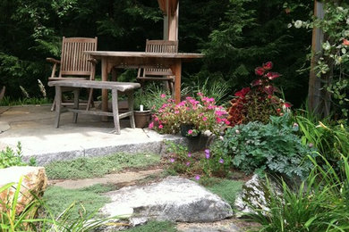 Photo of a backyard stone landscaping in Manchester.