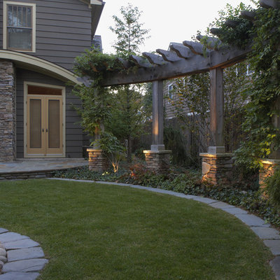 Design ideas for a mid-sized contemporary partial sun backyard stone lawn edging in Detroit.