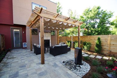 Photo of a mid-sized contemporary partial sun backyard concrete paver landscaping in Denver.