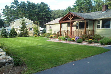 This is an example of a mid-sized traditional partial sun front yard gravel landscaping in Boston for spring.