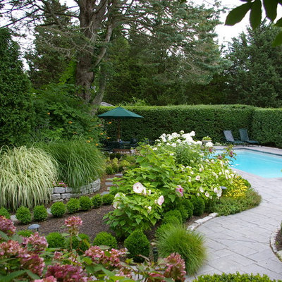 Design ideas for a traditional backyard retaining wall landscape in Boston.