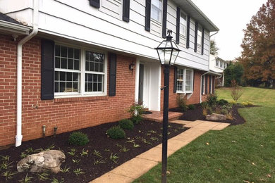 This is an example of a small traditional full sun front yard mulch landscaping in Baltimore.