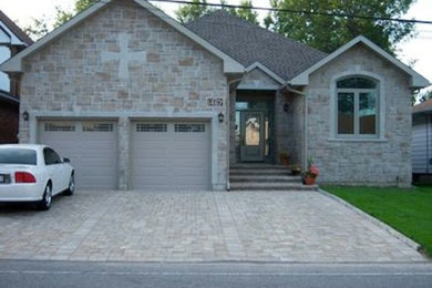 Inspiration for a mid-sized partial sun front yard concrete paver driveway in Montreal.