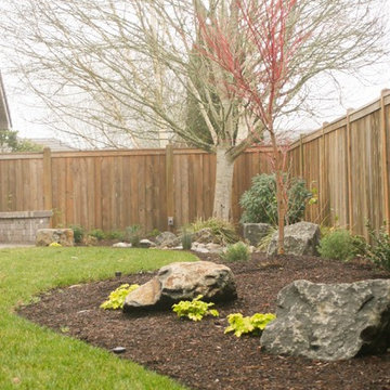 Planting beds with ornamental boulders as accents to plants.