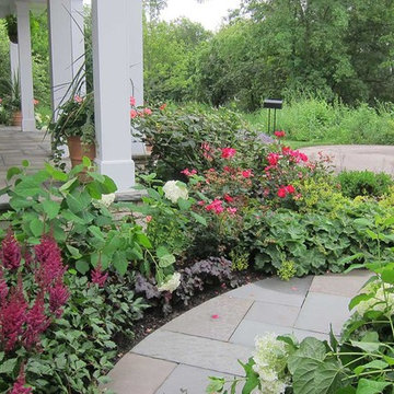 Plentiful sweeps of colorful perennials and foliage plants define the garden