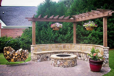 Inspiration for a traditional backyard stone landscaping in Atlanta with a fire pit.