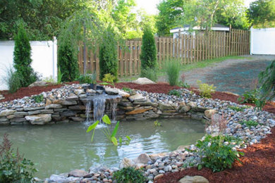 Design ideas for a mid-sized full sun mulch water fountain landscape in New York.