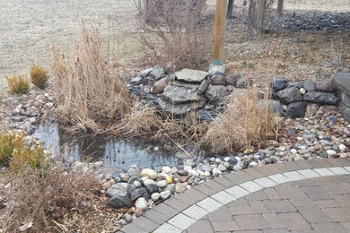 Photo of a small full sun backyard pond in Toronto.