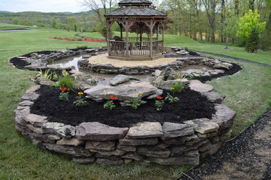 Design ideas for a large contemporary back garden in Baltimore with a water feature and mulch.