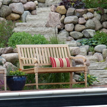 Pool side bench seating with boulder retaining wall