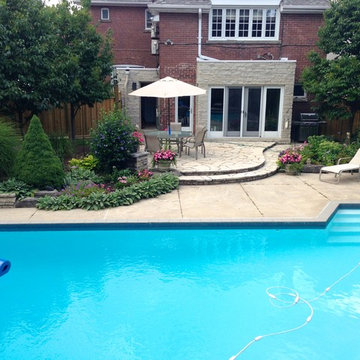 Pool side landscaping with a cedar fence and stone deck