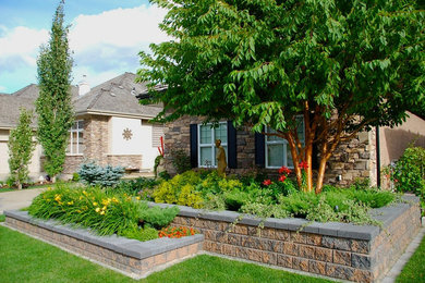 Inspiration for a mid-sized partial sun front yard concrete paver retaining wall landscape in Edmonton.