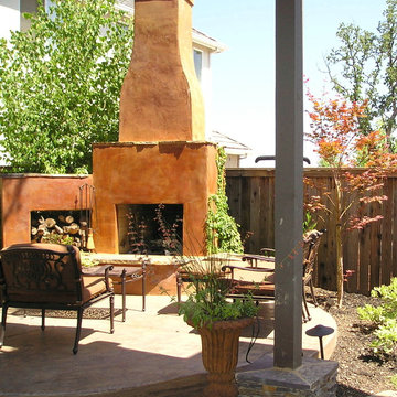 Rustic fireplace with urns and raised patio