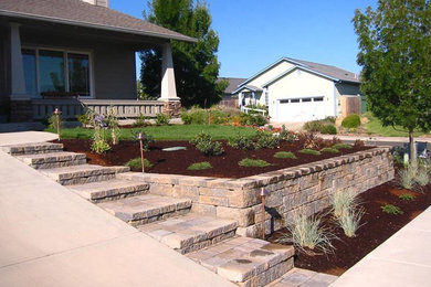 Design ideas for a full sun brick retaining wall landscape in Other.