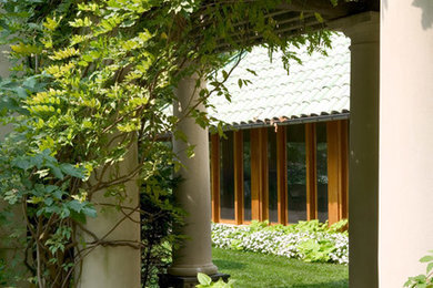 Photo of a large traditional partial sun courtyard concrete paver landscaping in Other for summer.