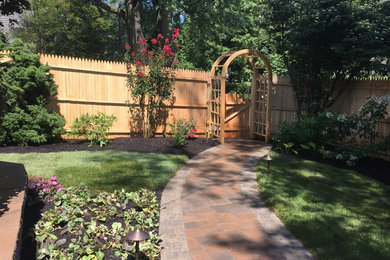 Photo of a medium sized rustic back formal partial sun garden in Philadelphia with a garden path and natural stone paving.