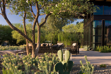 Design ideas for a mid-sized modern drought-tolerant and partial sun front yard concrete paver landscaping in Phoenix.