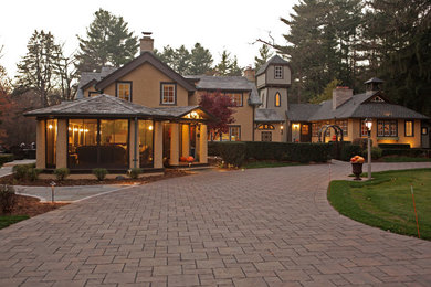 Design ideas for a large classic front driveway garden in Milwaukee with brick paving.