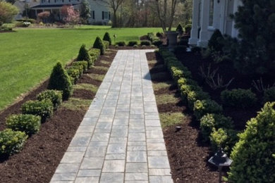Photo of a large classic garden in Cleveland with concrete paving.