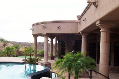 Photo of a southwestern drought-tolerant and full sun backyard concrete paver landscaping in Phoenix.