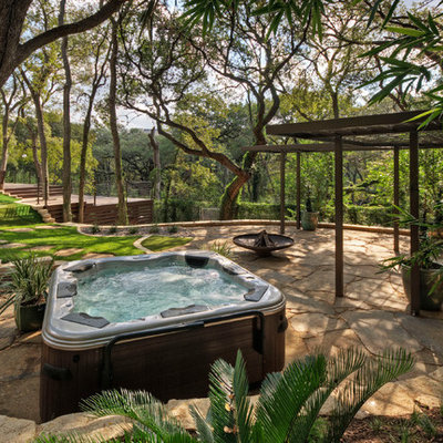 Design ideas for a large traditional shade hillside stone landscaping in Austin for summer.