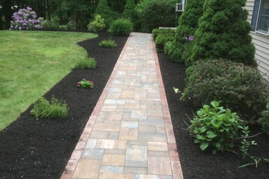 Inspiration for a medium sized traditional front full sun garden for summer in Boston with a garden path and natural stone paving.