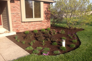 This is an example of a mid-sized full sun front yard concrete paver landscaping in Indianapolis.
