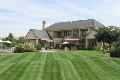 Photo of a huge traditional full sun backyard landscaping in Boise.
