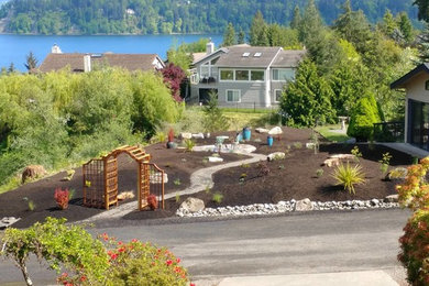 Medium sized classic back formal partial sun garden in Seattle with a garden path and natural stone paving.