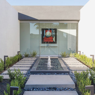 Photo of a contemporary courtyard concrete paver water fountain landscape in Other.