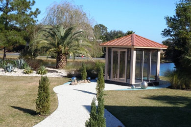 Design ideas for a mid-sized mediterranean side yard gravel garden path in Charleston.