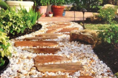 Design ideas for a mid-sized tropical full sun backyard gravel landscaping in Miami for spring.