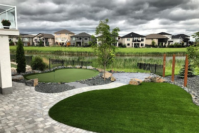 Photo of a mid-sized modern concrete paver landscaping in Other.