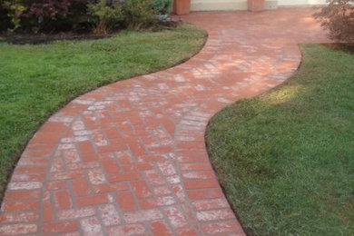 This is an example of a mid-sized traditional partial sun front yard brick garden path in San Francisco for summer.