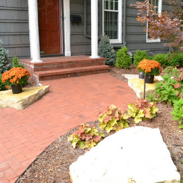 Reclaimed Brick Paver Sidewalk with Outcrop Stones and Landscaping