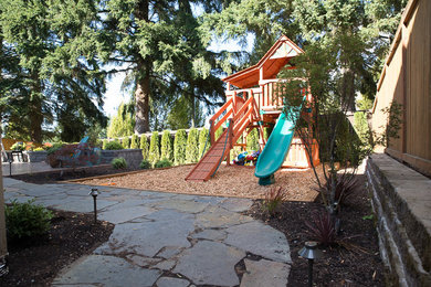 This is an example of a mid-sized contemporary partial sun backyard stone outdoor playset in Las Vegas.