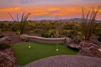 Design ideas for a large modern full sun backyard brick landscaping in Phoenix.