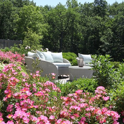 Photo of a large traditional full sun backyard stone formal garden in New York.