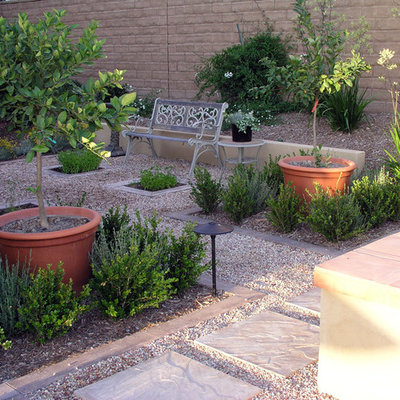 Photo of a mid-sized traditional drought-tolerant and partial sun backyard gravel landscaping in Los Angeles.