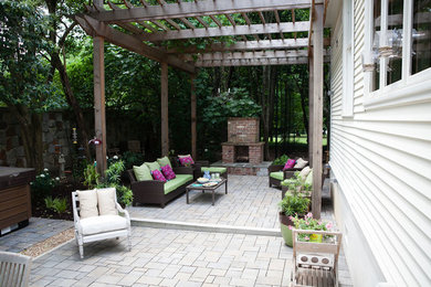 Inspiration for a mid-sized shabby-chic style drought-tolerant and partial sun backyard concrete paver landscaping in Atlanta with a fireplace for summer.