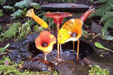 Classic back fully shaded garden in Seattle with a water feature.