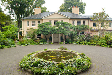 Photo of a large traditional concrete paver formal garden in Seattle.