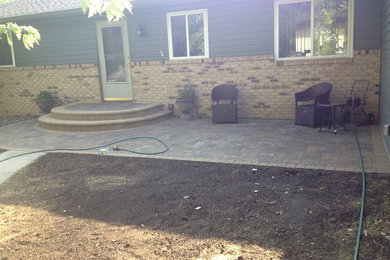 This is an example of a small traditional shade front yard concrete paver landscaping in Other.