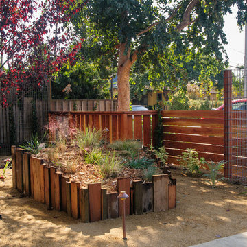 Repurposed wooden planters and Redwood fence.