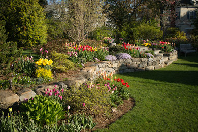 Photo of a large back full sun garden in New York with a water feature and concrete paving.