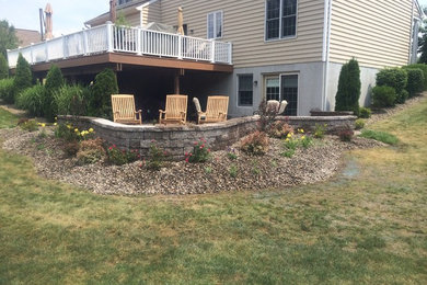 Inspiration for a large traditional full sun backyard concrete paver landscaping in Philadelphia with a fire pit.