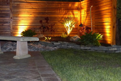 Design ideas for a small tropical backyard landscaping in Vancouver.
